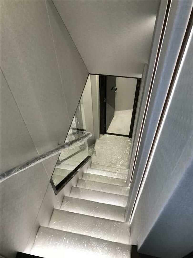 a staircase with a glass door aboard PURA VIDA Yacht for Sale