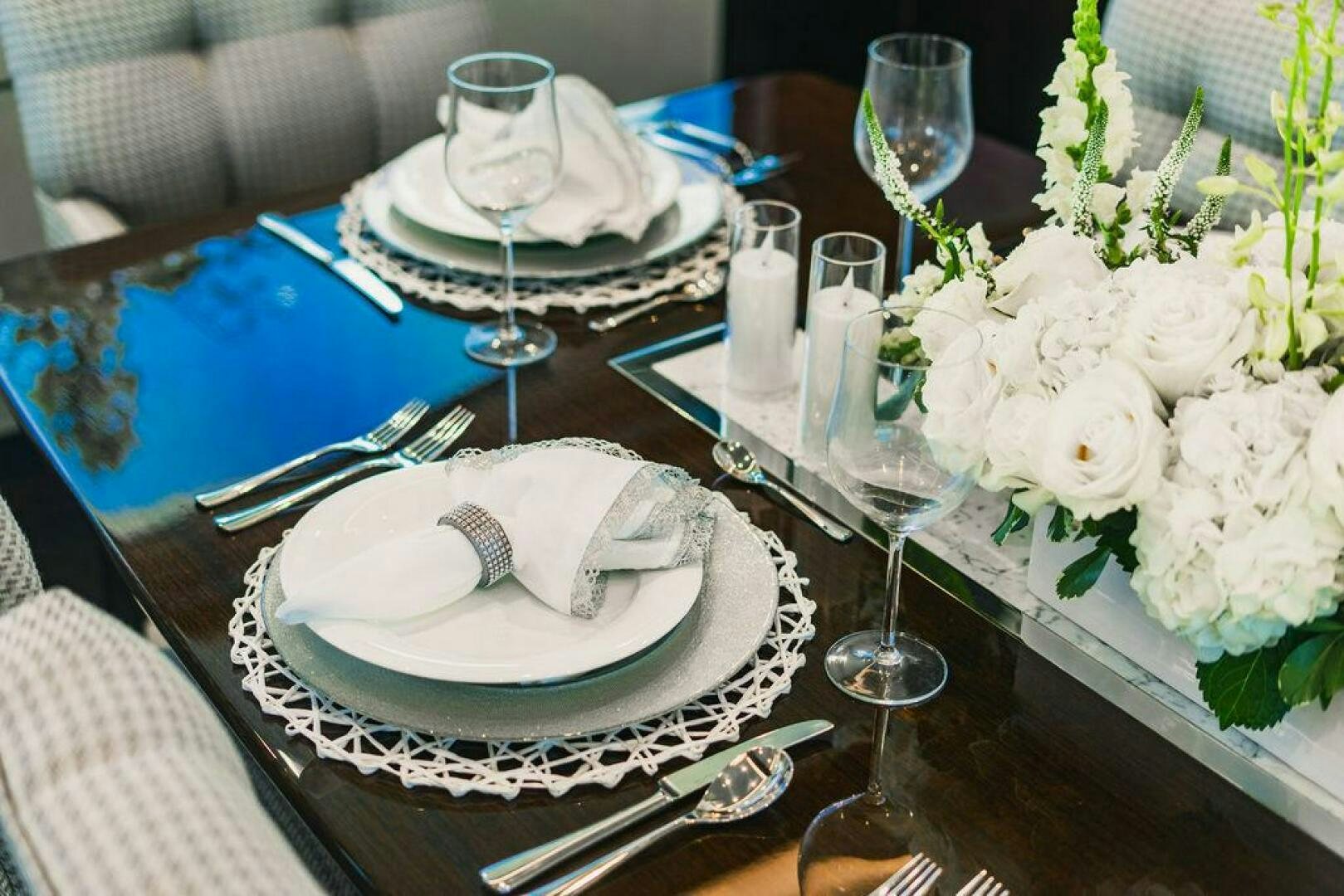 a table with plates and glasses aboard PURA VIDA Yacht for Sale