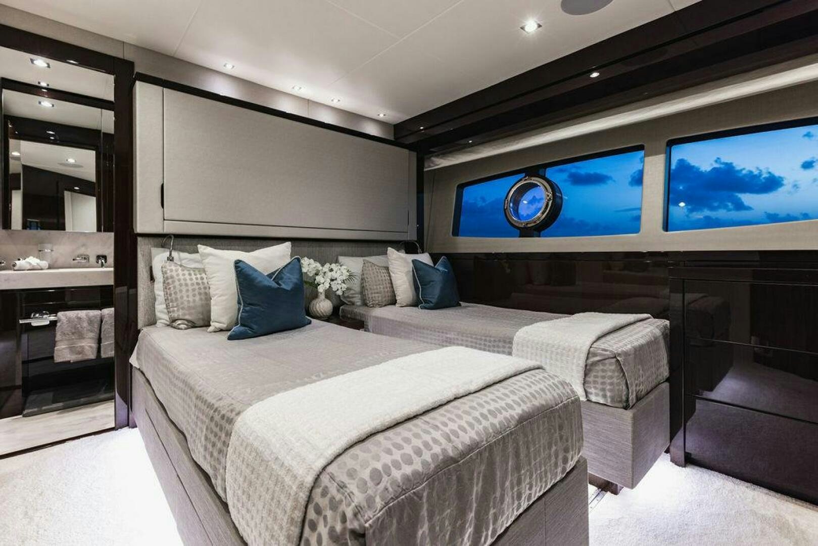 a room with a bed and a tv on the wall aboard PURA VIDA Yacht for Sale