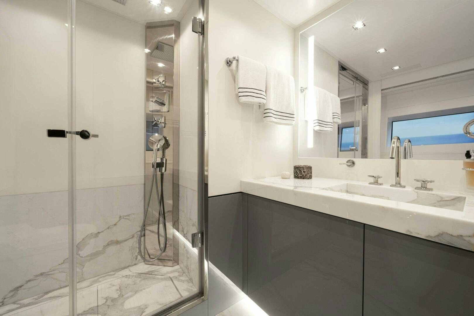 a bathroom with a glass shower aboard ARTEMIS Yacht for Sale