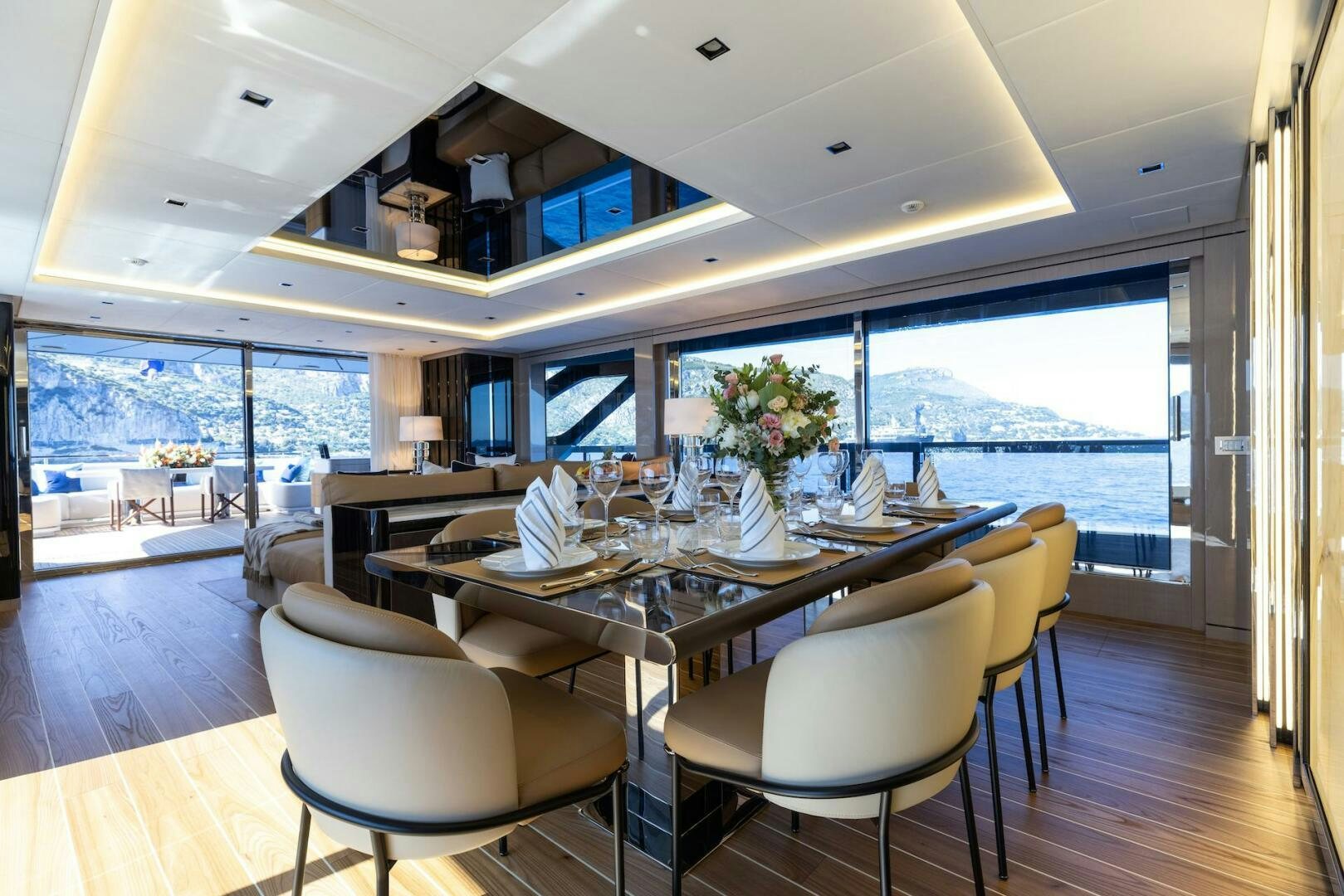 a large dining table with a view of the ocean aboard ARTEMIS Yacht for Sale