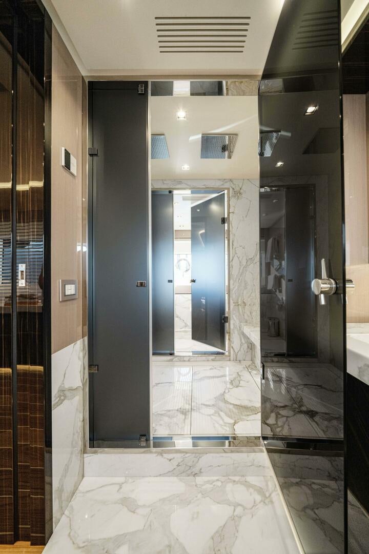 a large bathroom with glass doors aboard ARTEMIS Yacht for Sale
