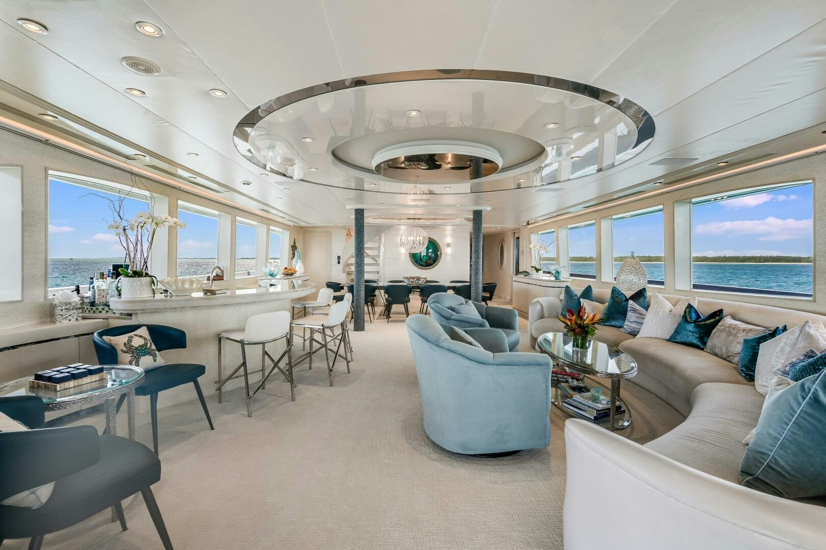 a living room with a large chandelier aboard CUPCAKE Yacht for Sale
