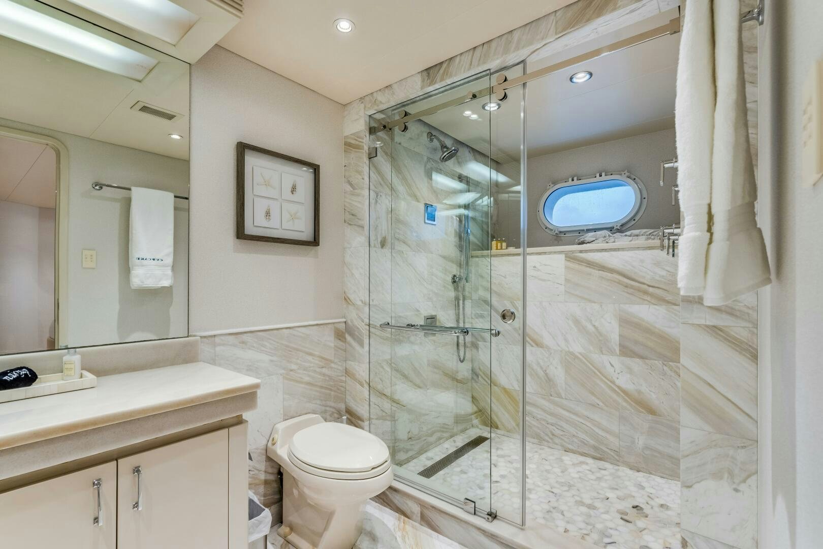 a bathroom with a glass shower aboard CUPCAKE Yacht for Sale