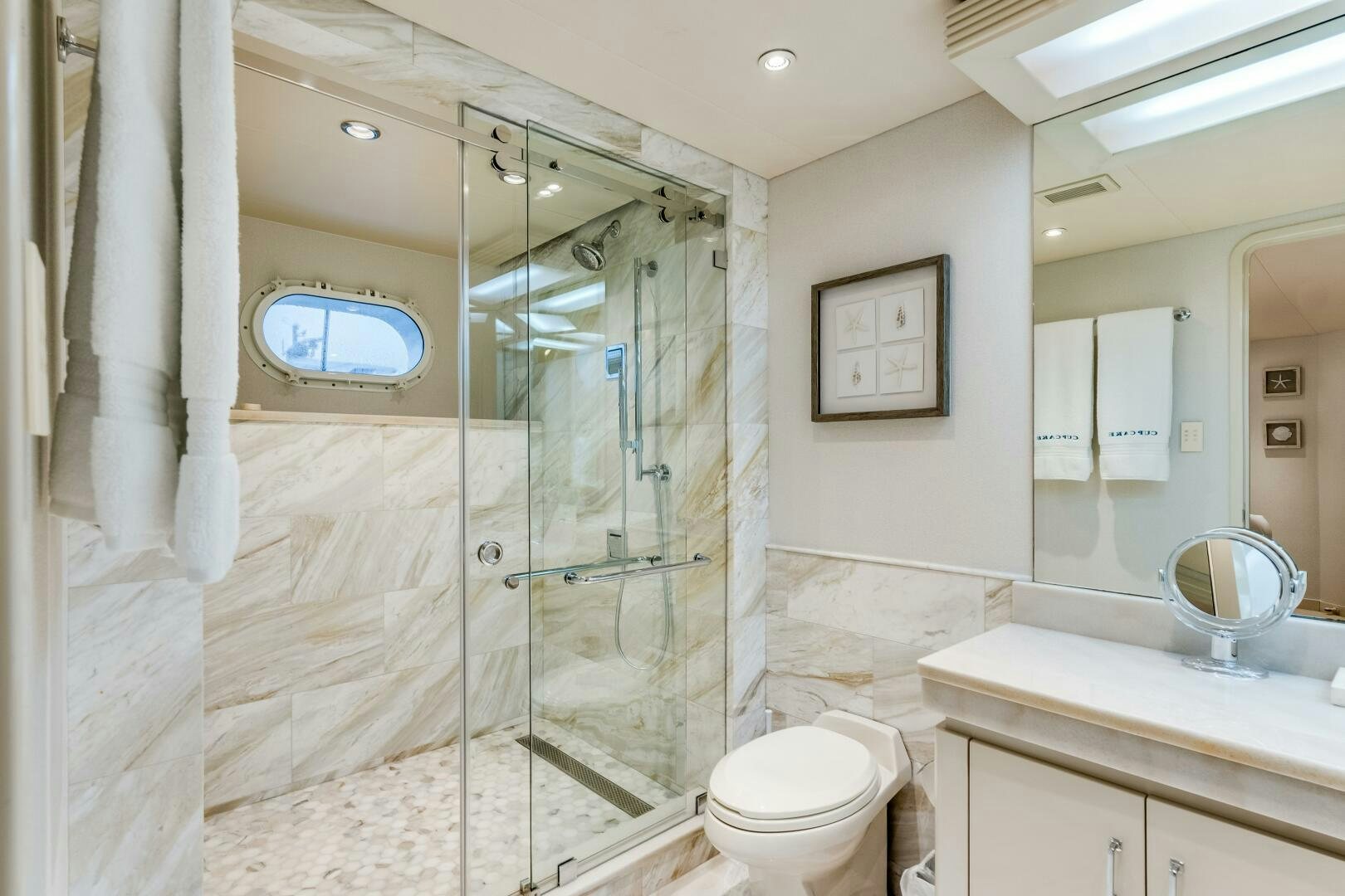 a bathroom with a glass shower aboard CUPCAKE Yacht for Sale