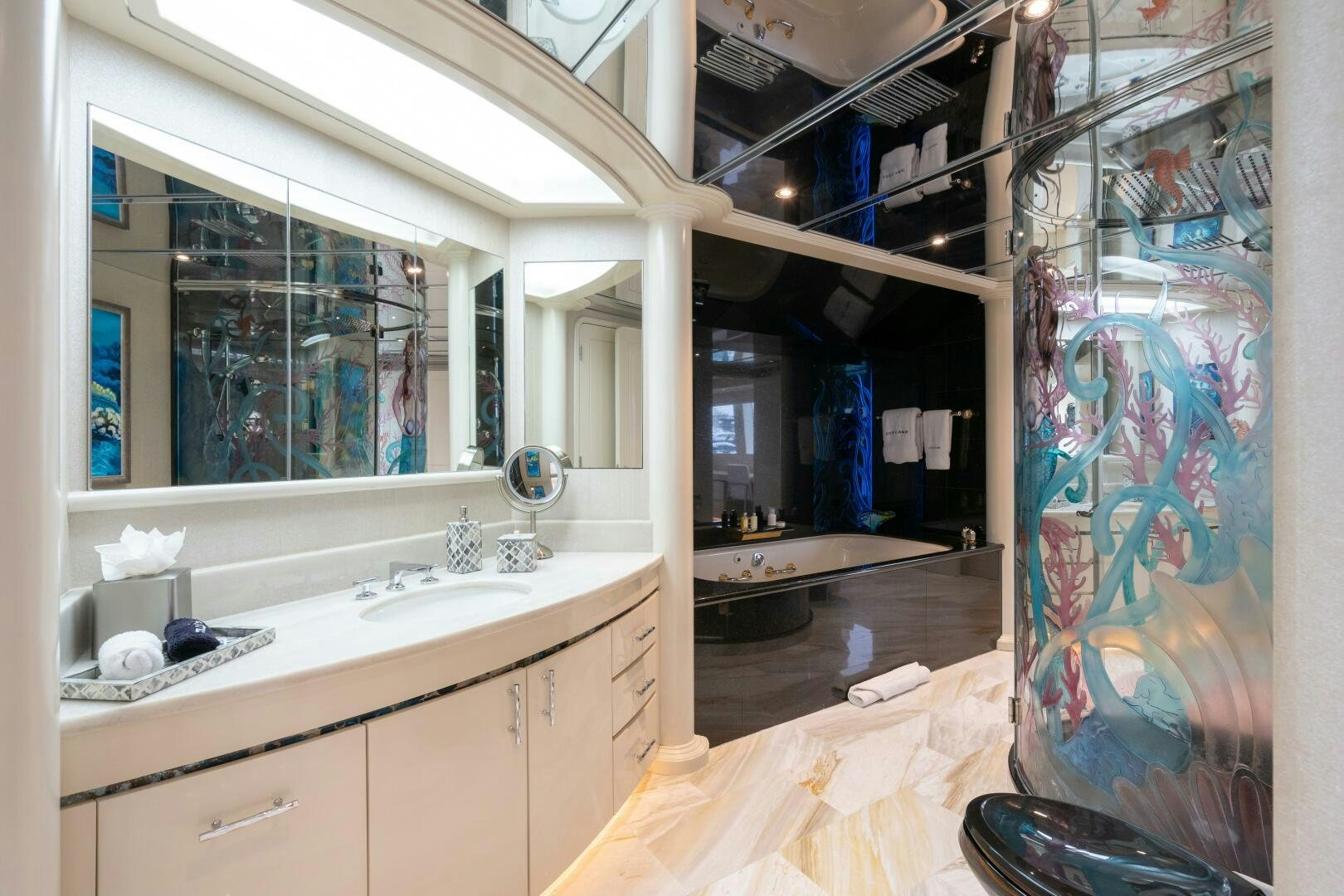 a bathroom with a sink and a large mirror aboard CUPCAKE Yacht for Sale