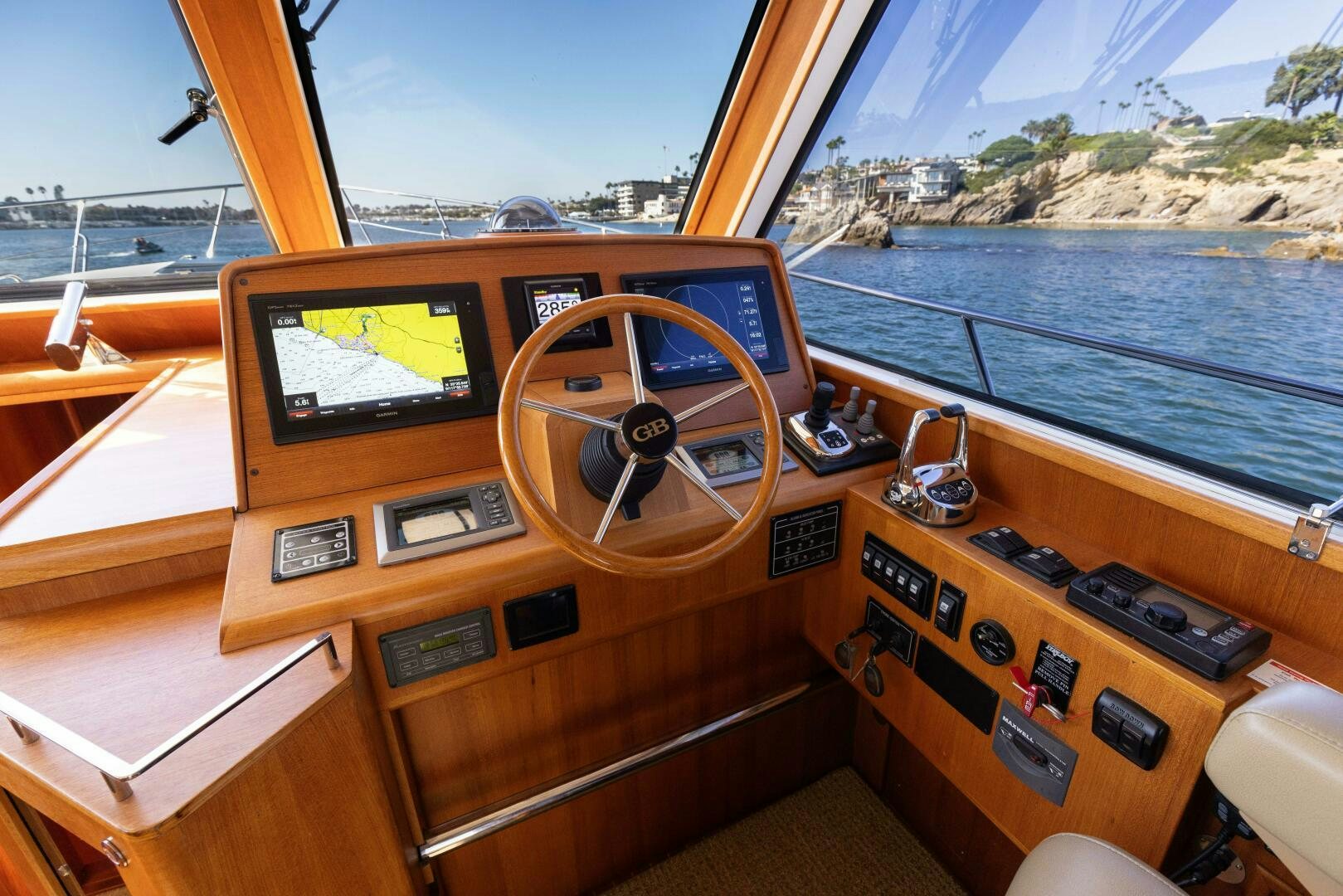a wooden boat with a steering wheel aboard FINALLY US Yacht for Sale