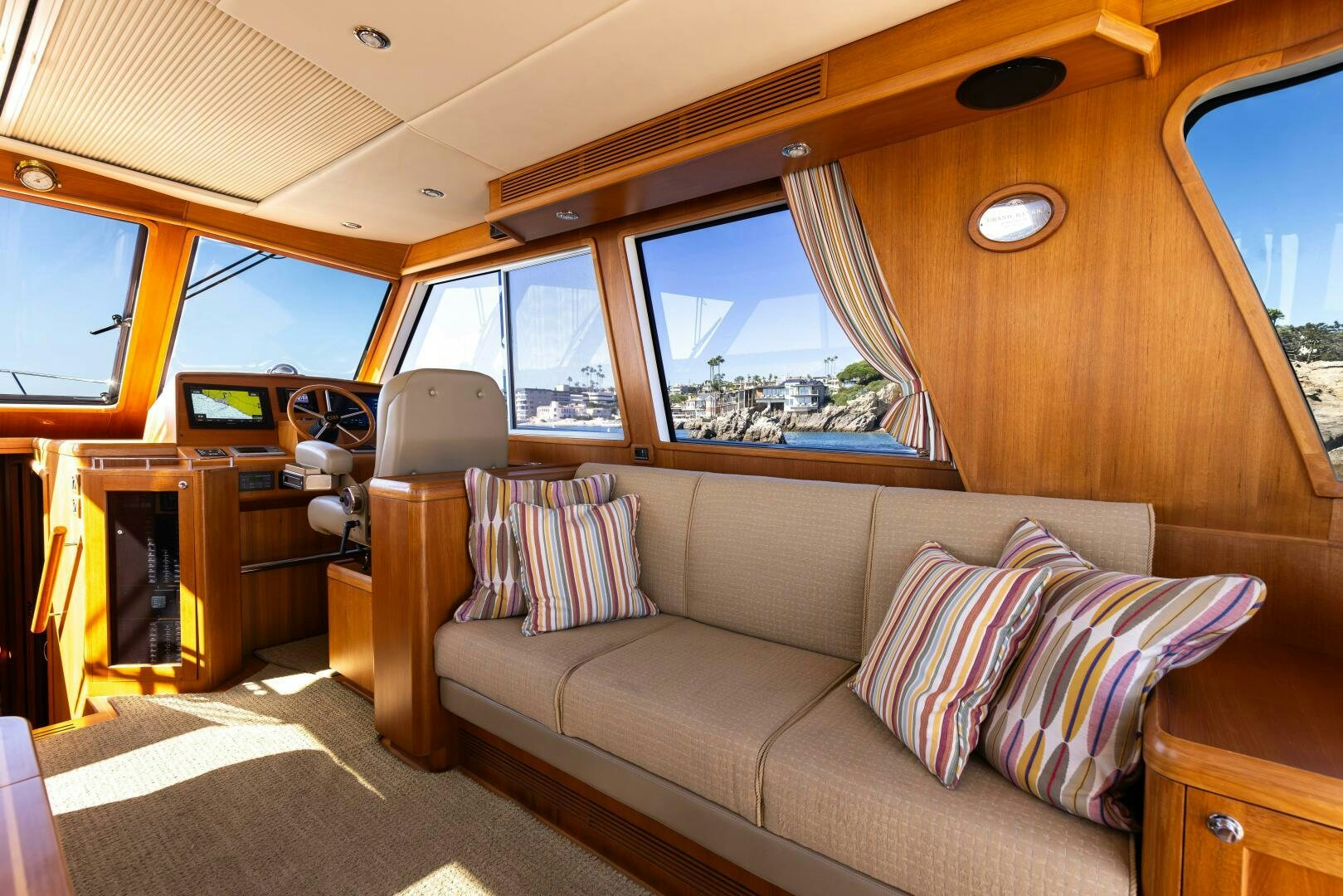 a cabin with a couch and a window aboard FINALLY US Yacht for Sale
