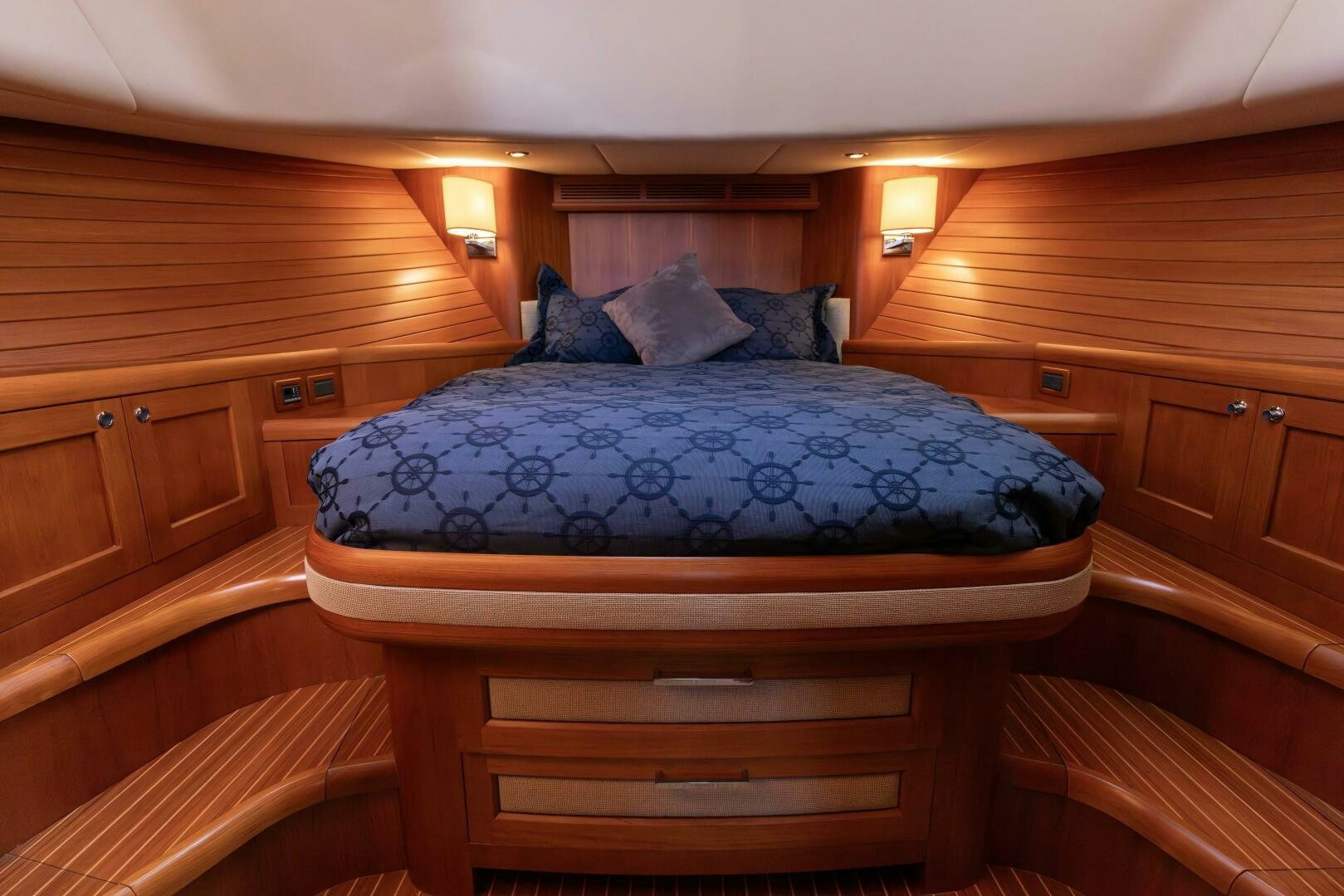 a bed with blue sheets aboard FINALLY US Yacht for Sale