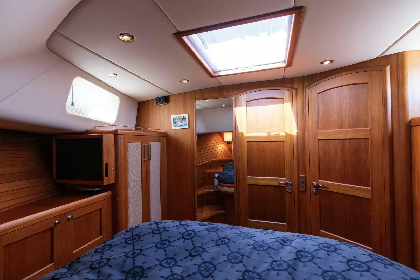 a bedroom with a bed and a television aboard FINALLY US Yacht for Sale
