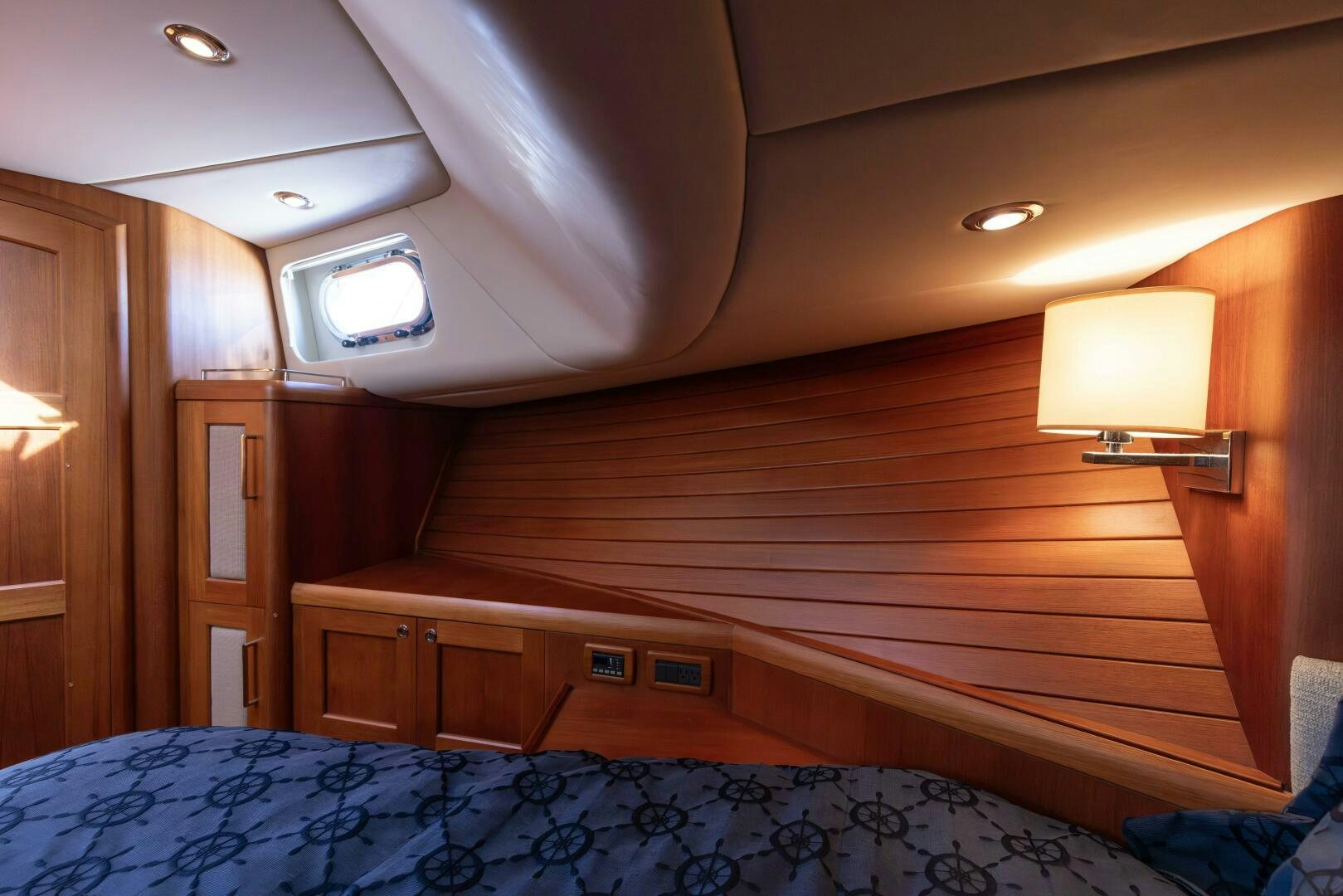 a bed with a blue sheet aboard FINALLY US Yacht for Sale