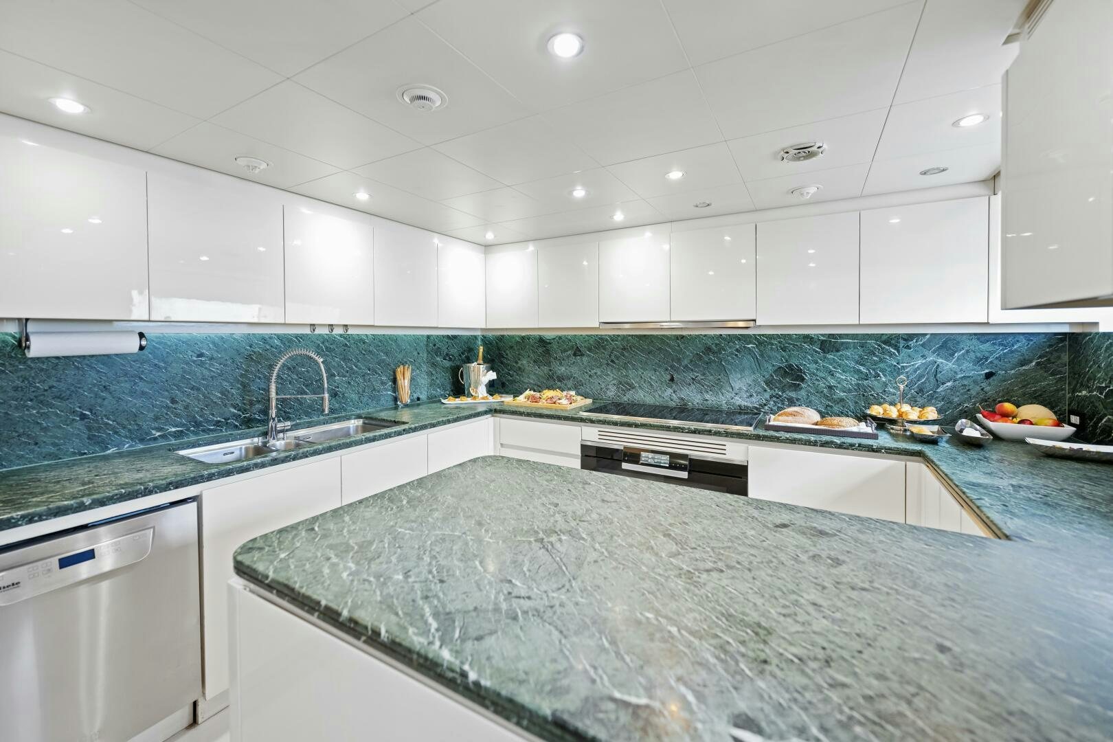 a kitchen with a marble counter top aboard GLADIUS Yacht for Sale