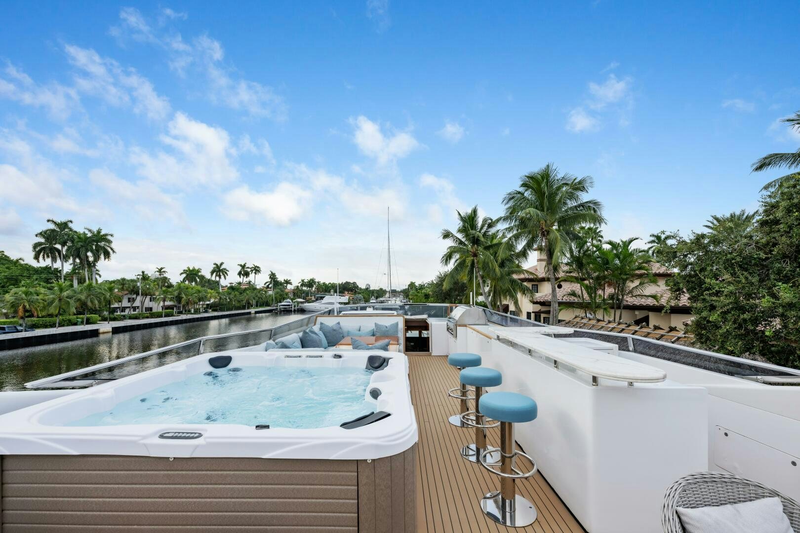 a large pool with a deck and trees and a blue sky aboard GLADIUS Yacht for Sale