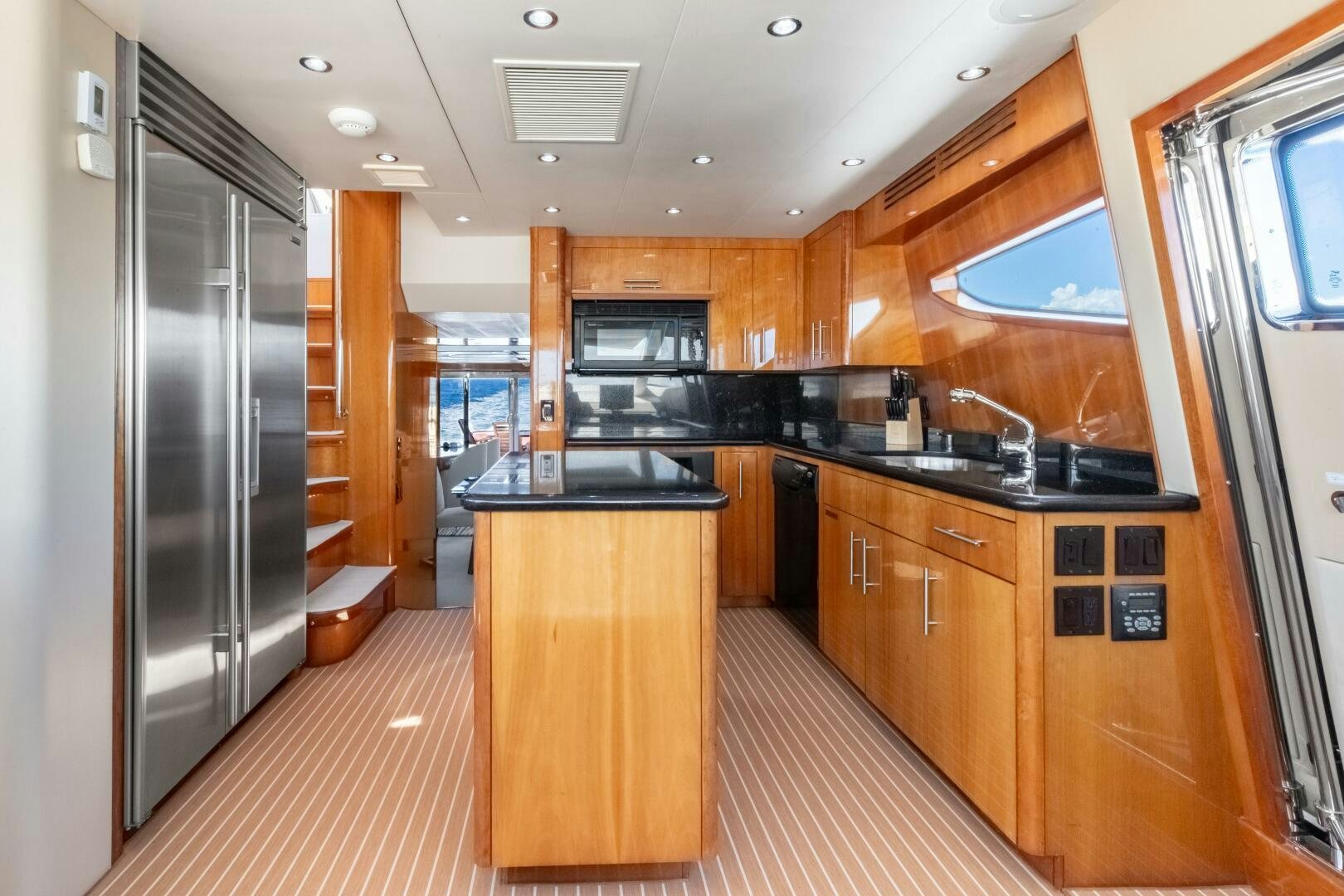 a kitchen with wooden cabinets aboard PIRATE RADIO Yacht for Sale