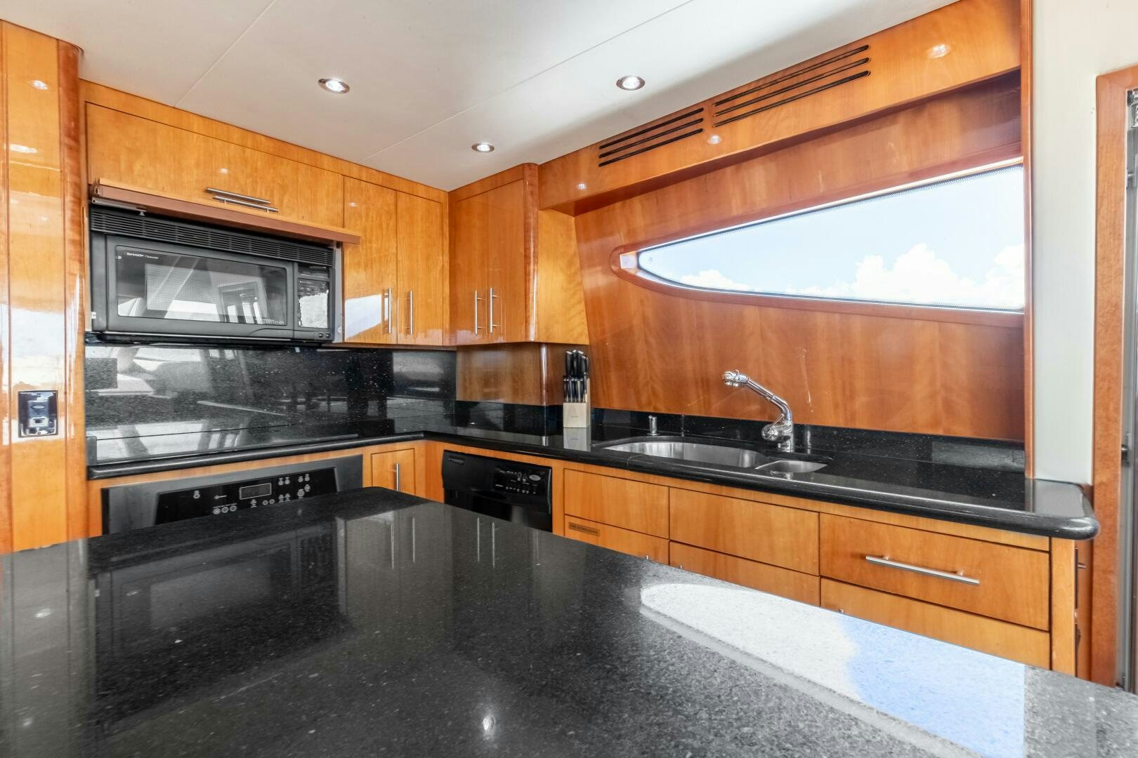 a kitchen with a black stove and a black countertop aboard PIRATE RADIO Yacht for Sale