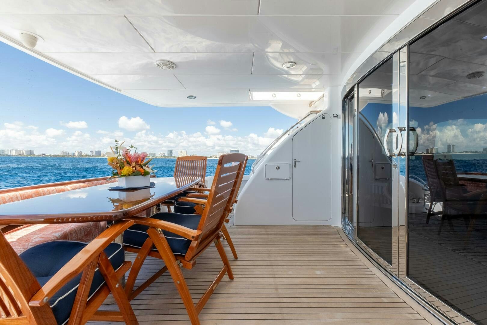 a deck with a table and chairs on it aboard PIRATE RADIO Yacht for Sale