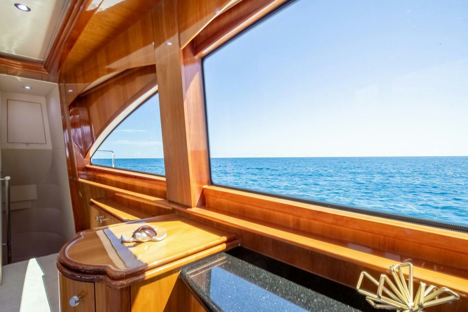 a boat with a table and a book on it aboard PIRATE RADIO Yacht for Sale