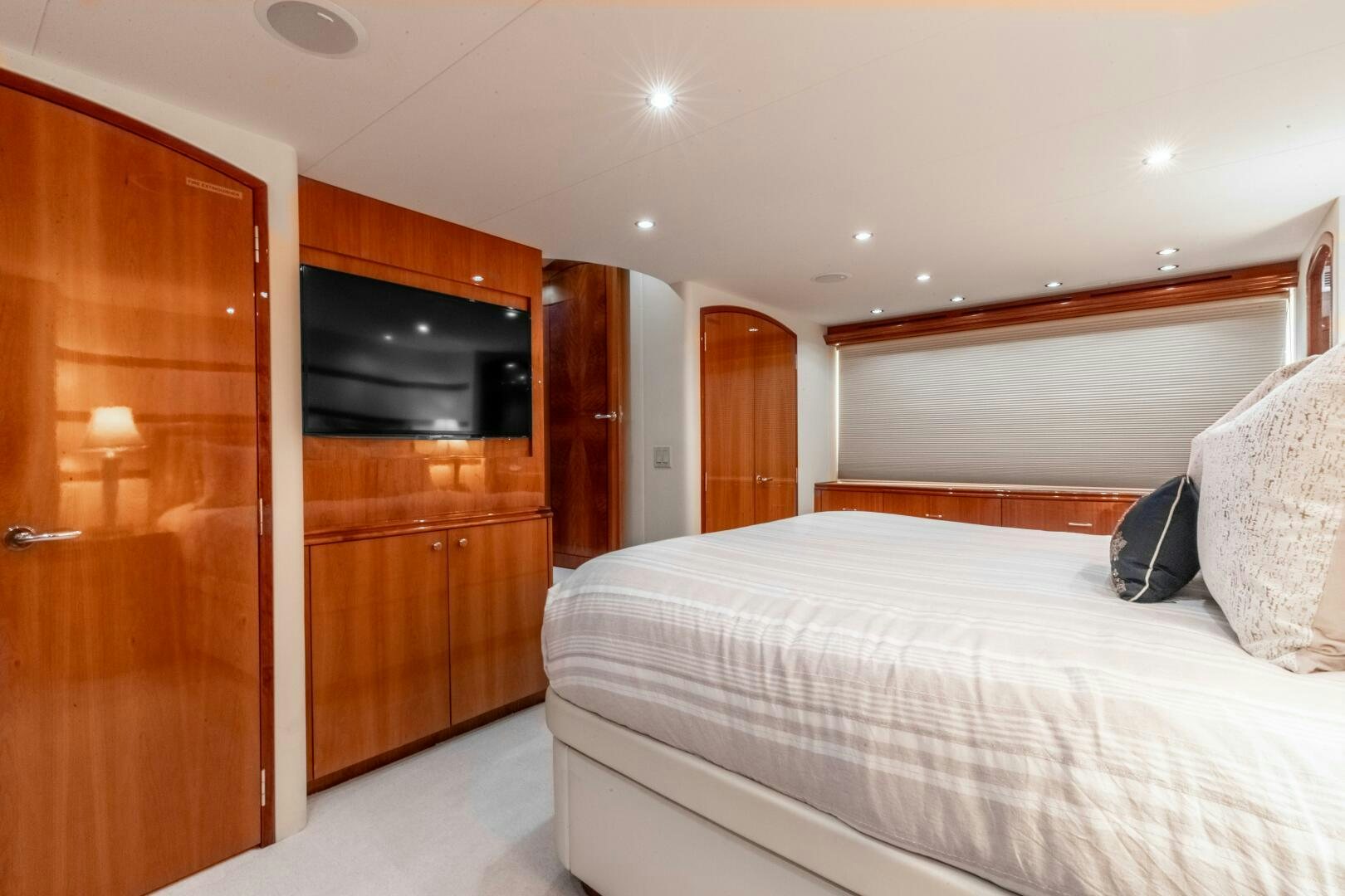 a bedroom with a bed and a television aboard PIRATE RADIO Yacht for Sale