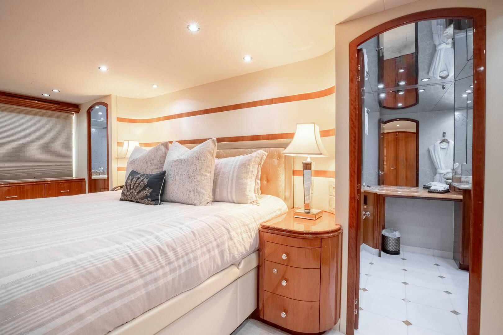 a bedroom with a bed and a mirror aboard PIRATE RADIO Yacht for Sale