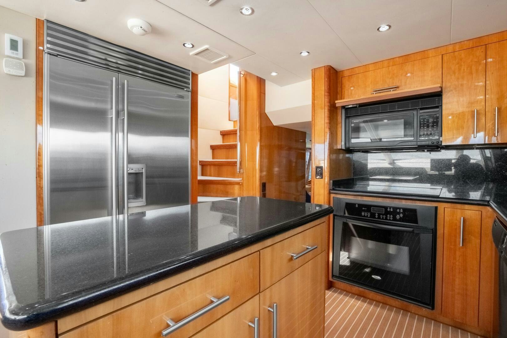 a kitchen with a stainless steel refrigerator aboard PIRATE RADIO Yacht for Sale