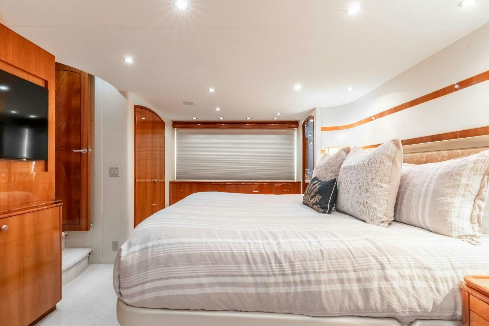 a bed with pillows and a television aboard PIRATE RADIO Yacht for Sale