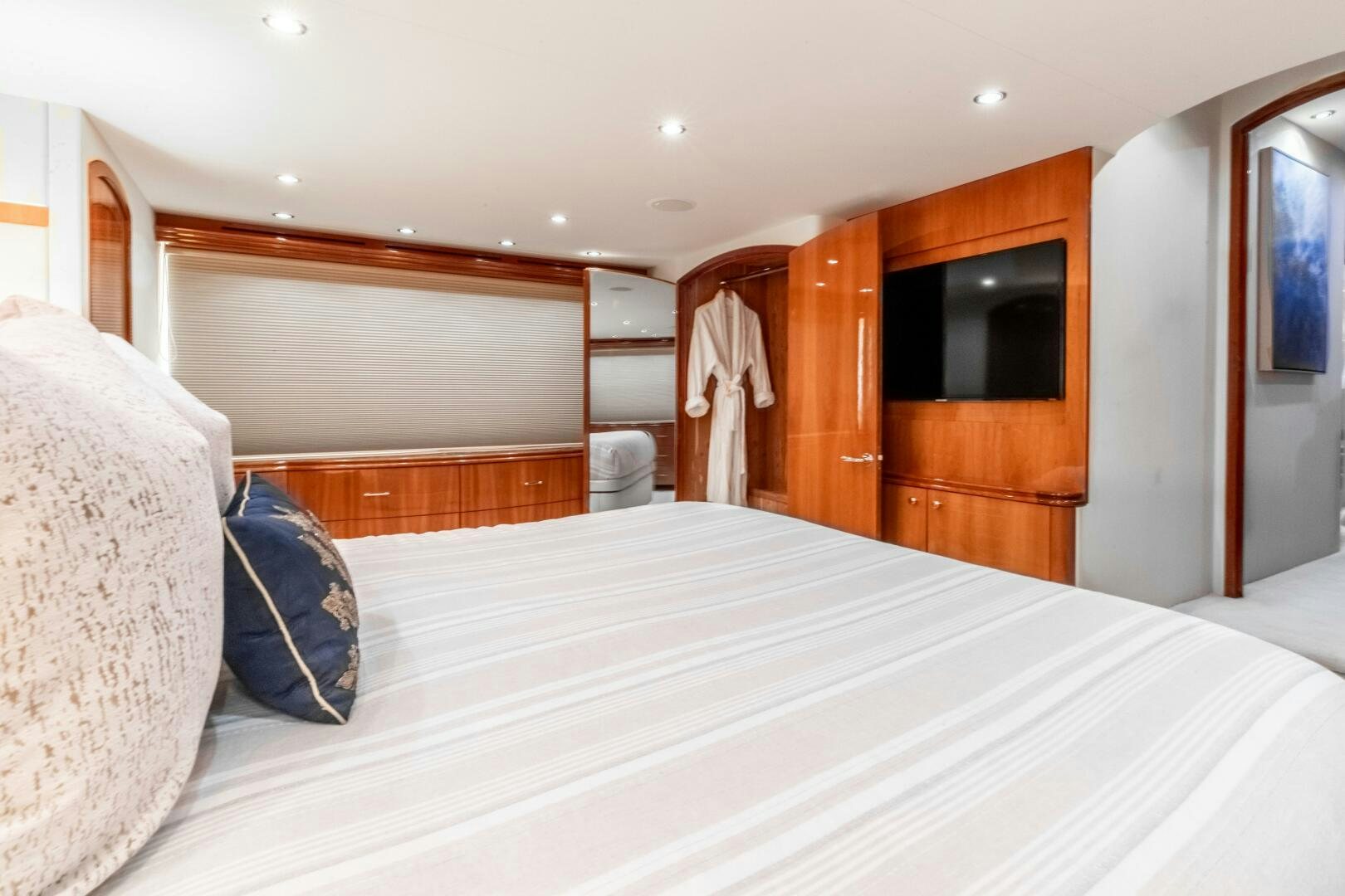 a bed with white sheets and pillows aboard PIRATE RADIO Yacht for Sale