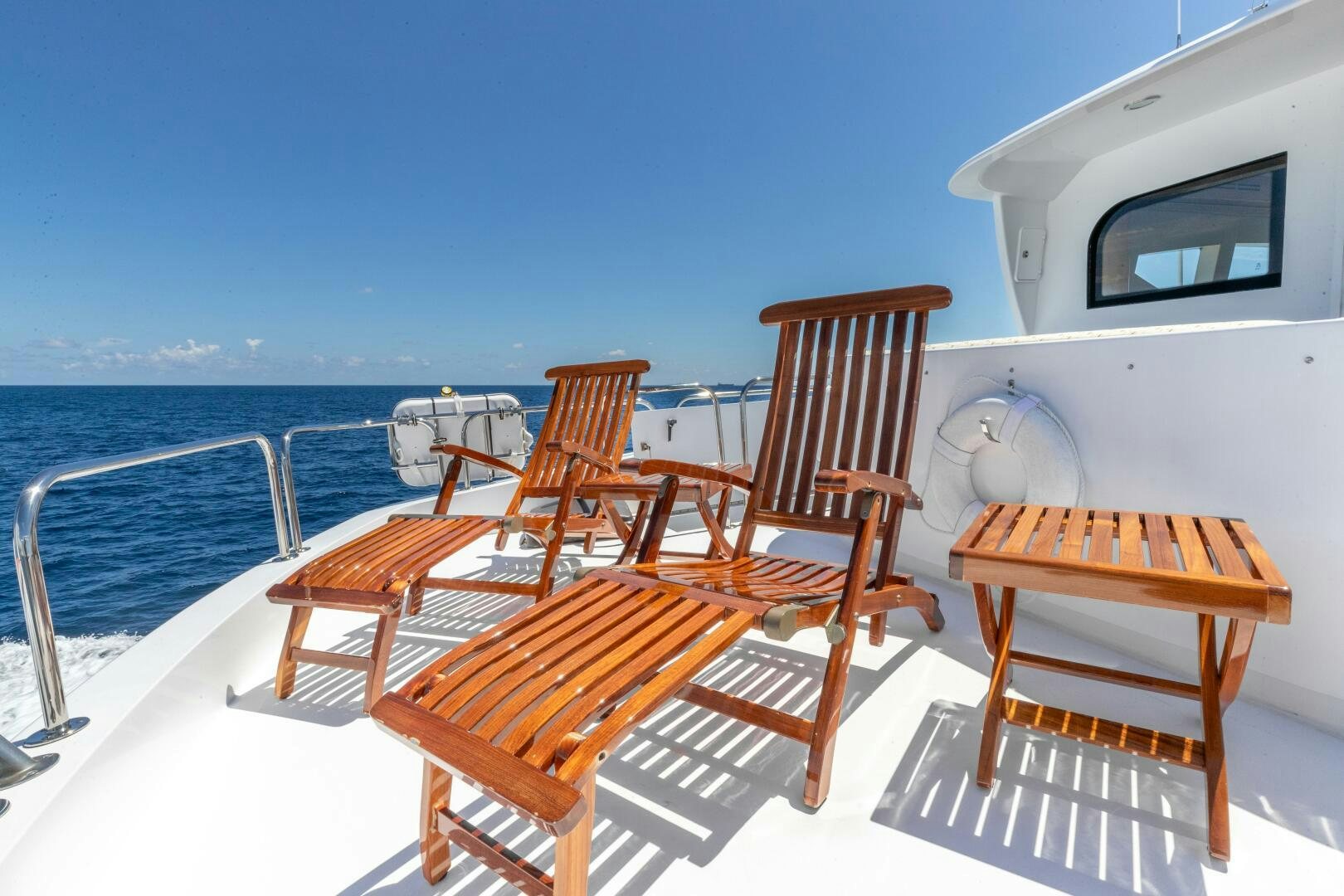 a deck with chairs on it aboard PIRATE RADIO Yacht for Sale