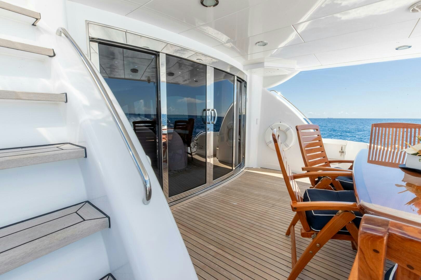 a boat with a table and chairs aboard PIRATE RADIO Yacht for Sale