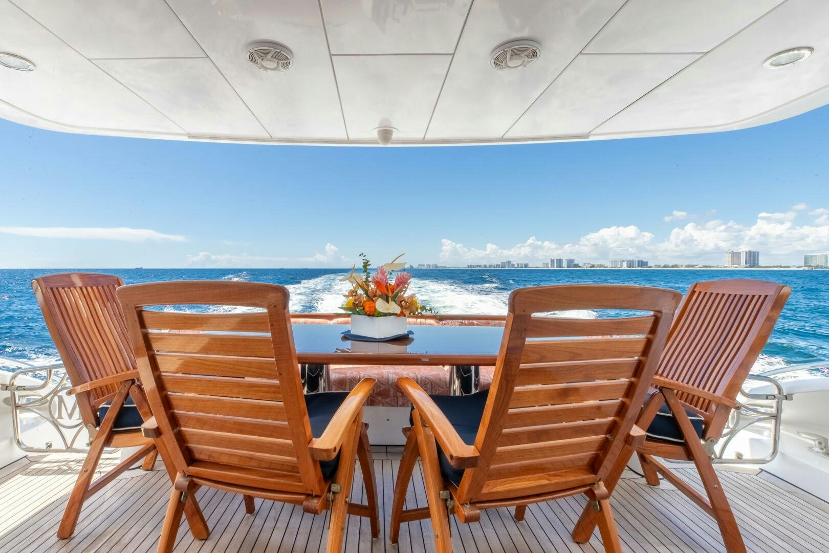 a table and chairs on a deck overlooking a large body of water aboard PIRATE RADIO Yacht for Sale