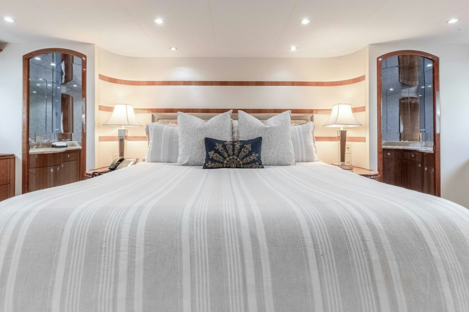 a bed with a white comforter aboard PIRATE RADIO Yacht for Sale