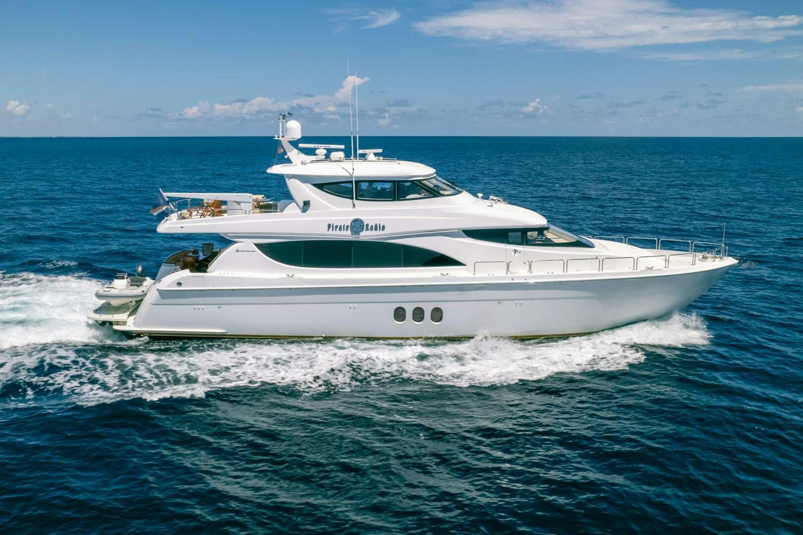 a white yacht in the water aboard PIRATE RADIO Yacht for Sale