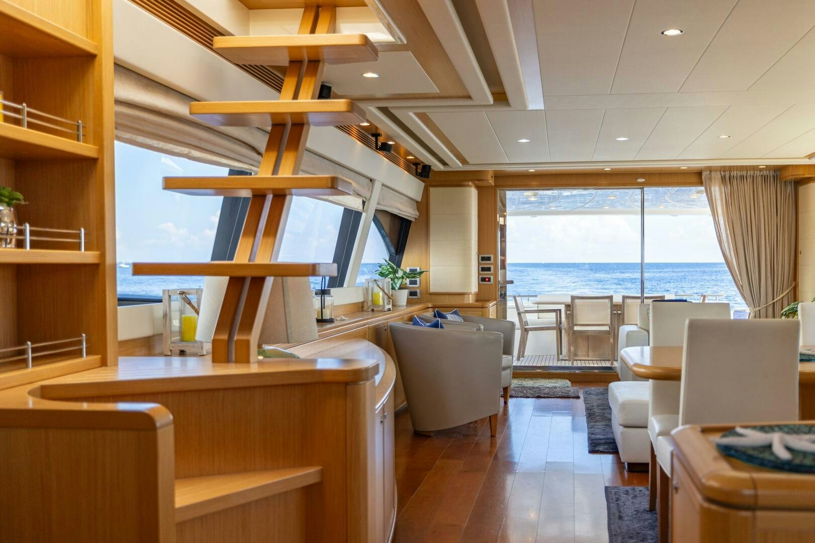 a room with a wood table and chairs and a wood ladder aboard CRYSTAL PARROT Yacht for Sale