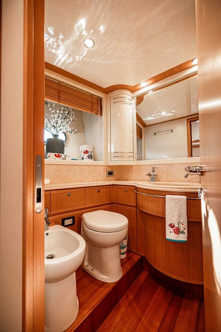 a bathroom with a toilet and sink aboard CRYSTAL PARROT Yacht for Sale