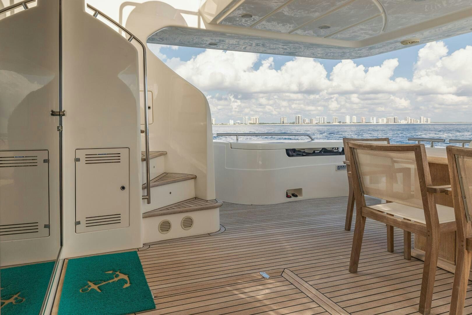 a room with a chair and a table and a view of the ocean aboard CRYSTAL PARROT Yacht for Sale