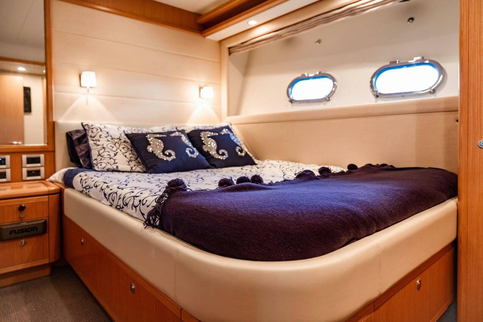 a bed with blue sheets aboard CRYSTAL PARROT Yacht for Sale