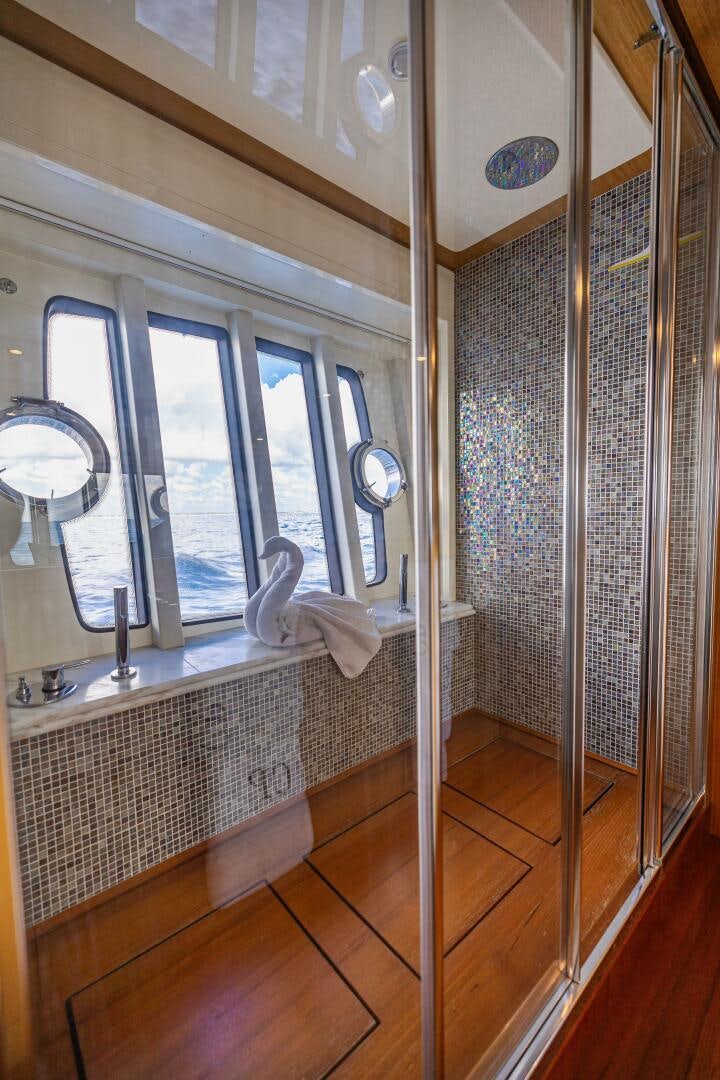 a bathroom with a glass shower aboard CRYSTAL PARROT Yacht for Sale