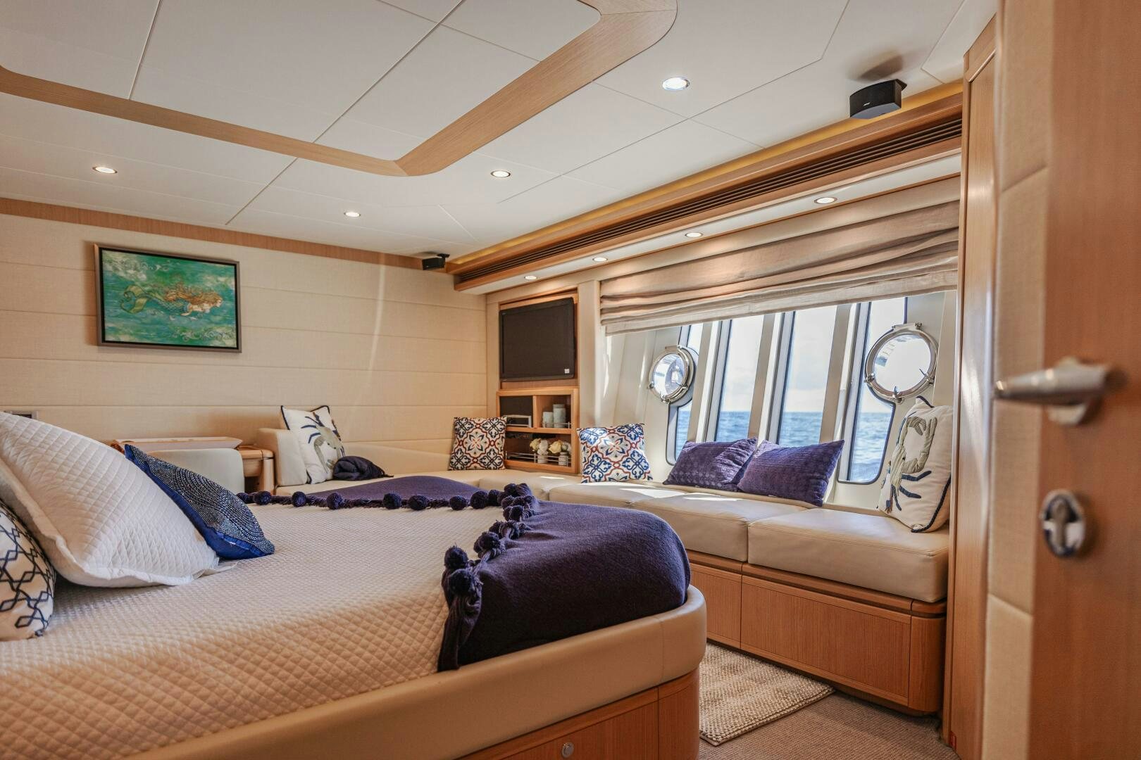 a bedroom with a bed and a couch aboard CRYSTAL PARROT Yacht for Sale