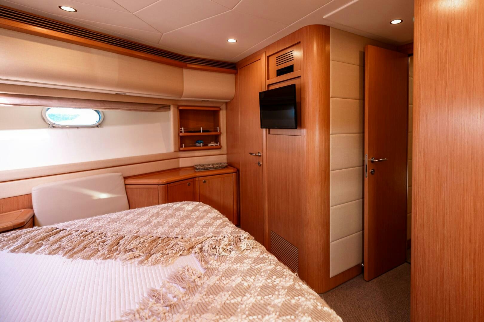 a bedroom with a bed and a television aboard CRYSTAL PARROT Yacht for Sale