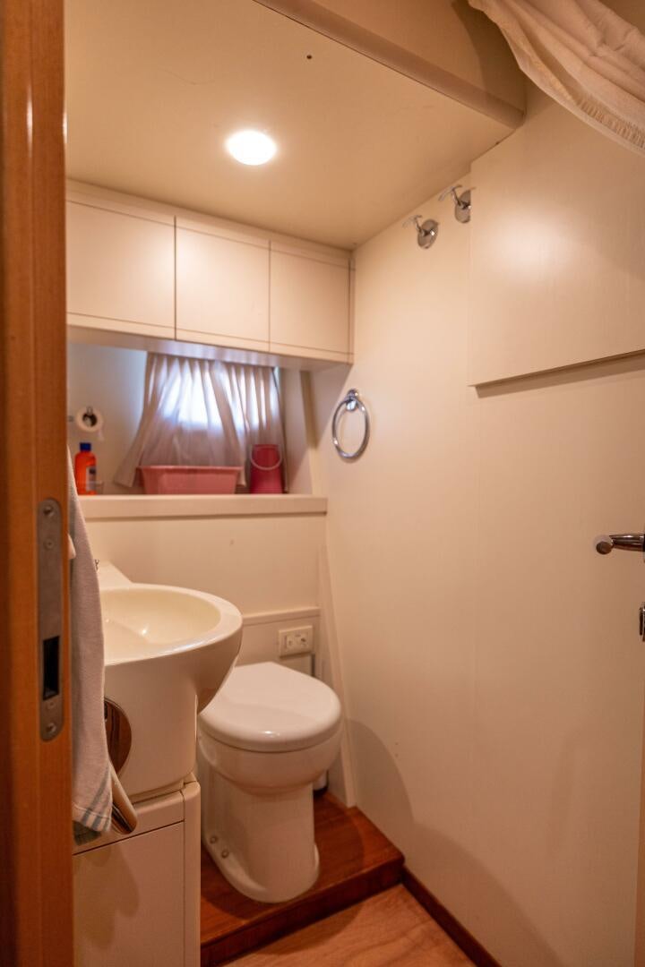 a bathroom with a toilet and sink aboard CRYSTAL PARROT Yacht for Sale