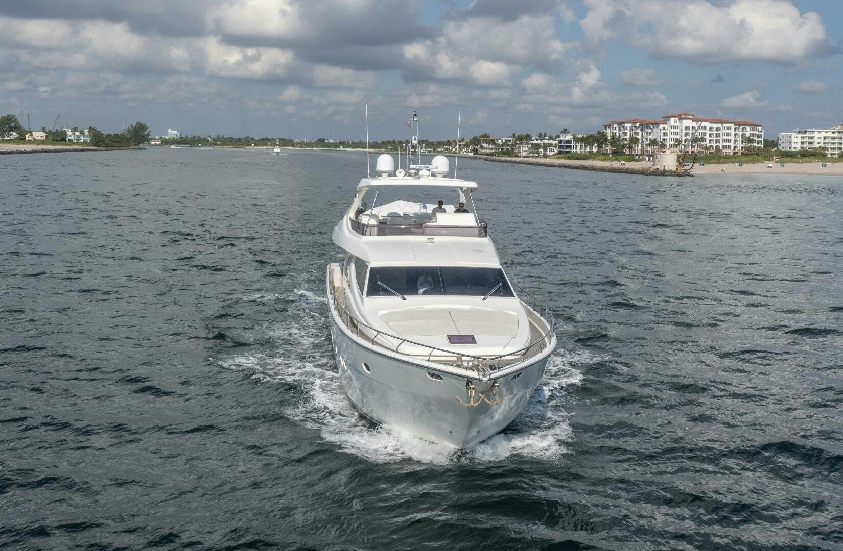 a white boat on the water aboard CRYSTAL PARROT Yacht for Sale