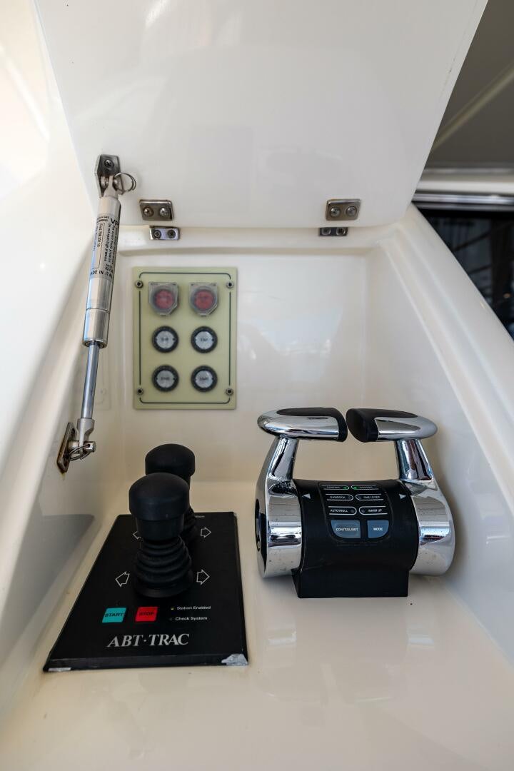 a white car with a black steering wheel and a black box on the side aboard CRYSTAL PARROT Yacht for Sale