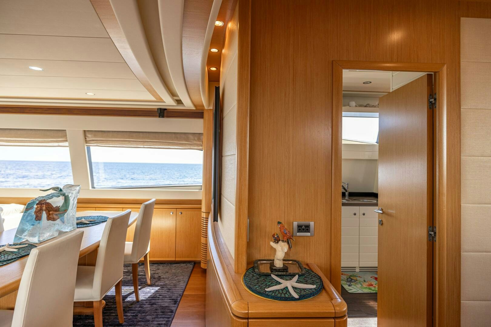 a room with a table and chairs aboard CRYSTAL PARROT Yacht for Sale