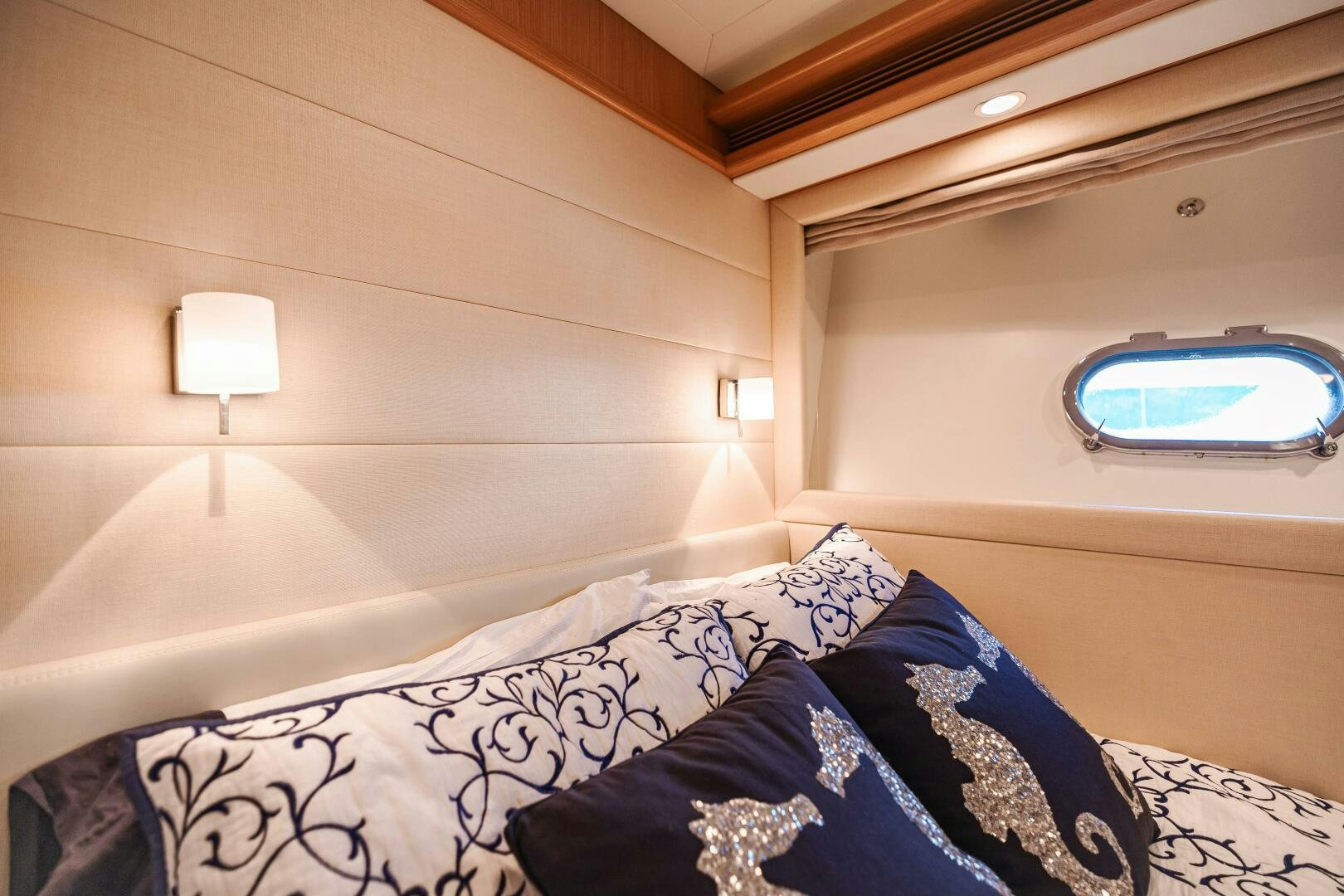 a bed with a blue blanket aboard CRYSTAL PARROT Yacht for Sale