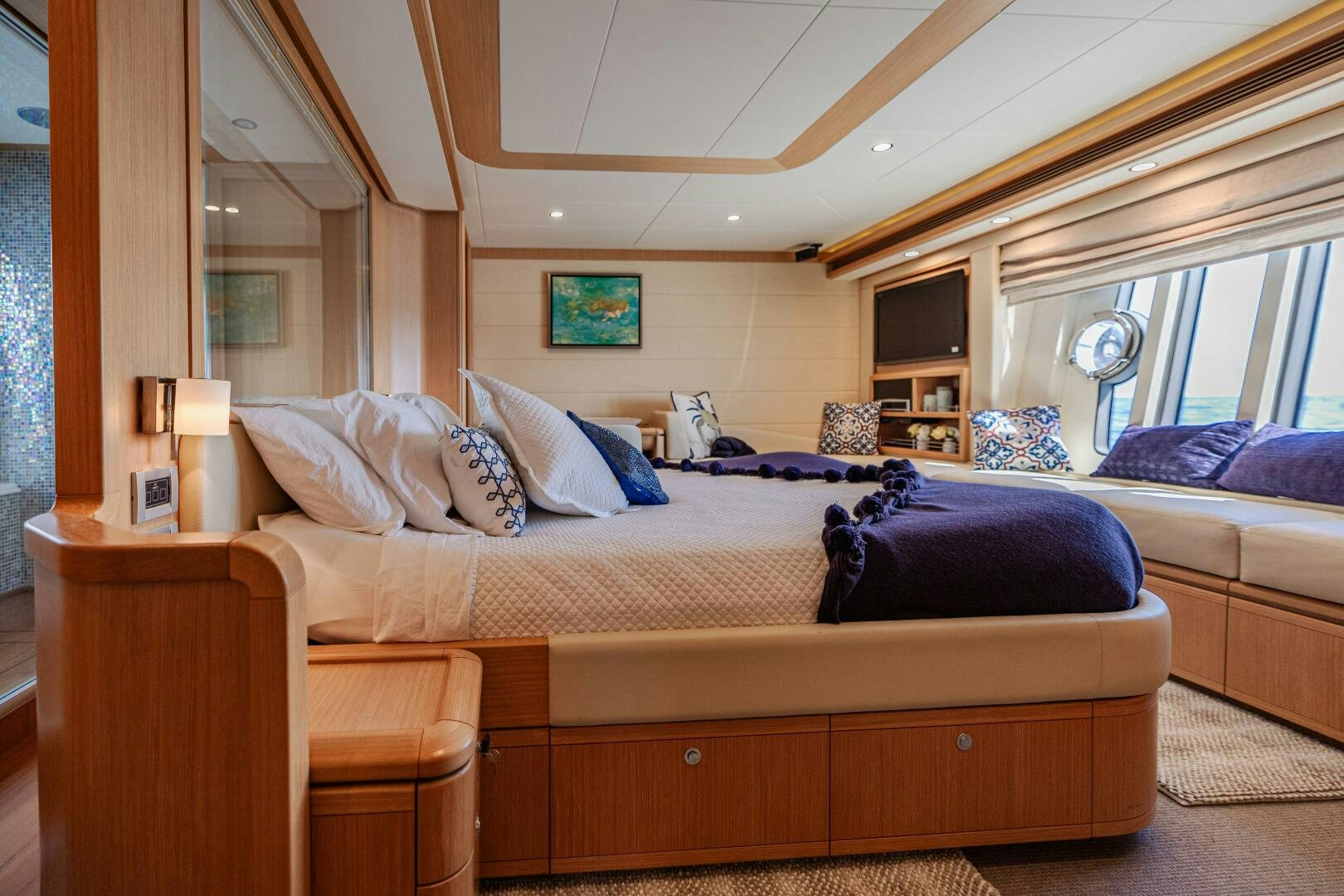 a bed with a blue blanket aboard CRYSTAL PARROT Yacht for Sale