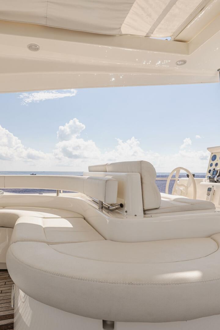 a white boat with a white canopy aboard CRYSTAL PARROT Yacht for Sale