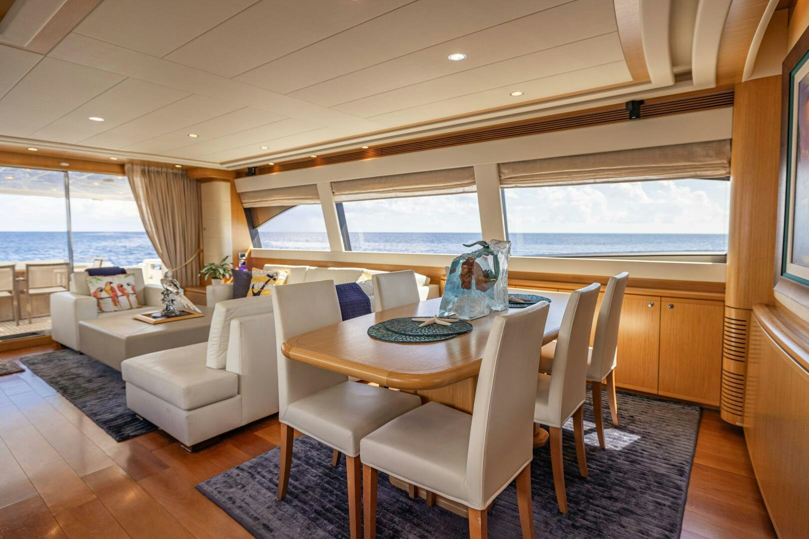 a dining room with a table and chairs aboard CRYSTAL PARROT Yacht for Sale