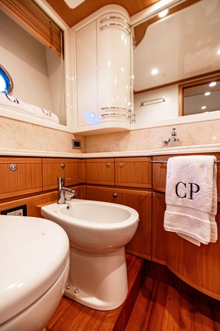 a bathroom with wooden cabinets aboard CRYSTAL PARROT Yacht for Sale