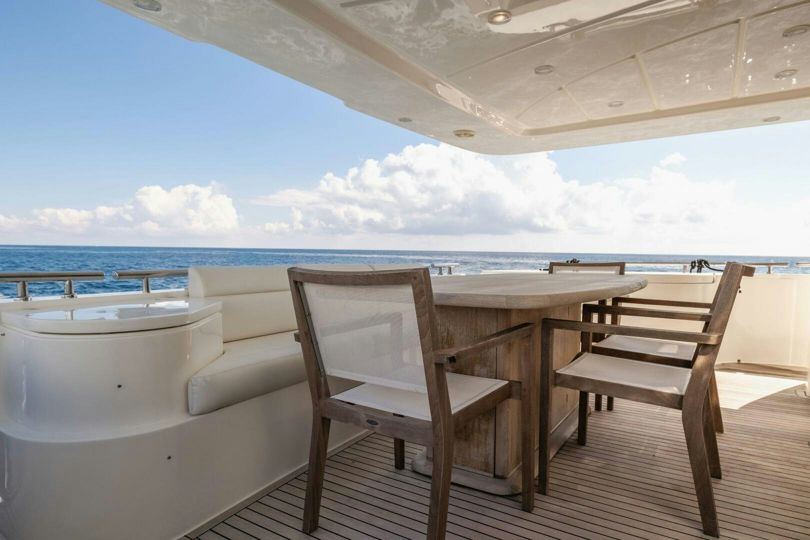 a table and chairs on a deck aboard CRYSTAL PARROT Yacht for Sale