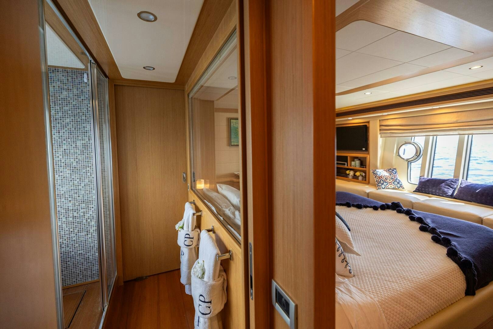 a bedroom with a large mirror aboard CRYSTAL PARROT Yacht for Sale