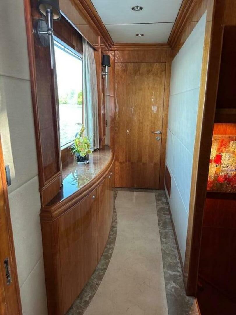a hallway with a door and windows aboard MOJITO Yacht for Sale